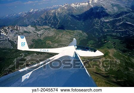 Glider plane Duo Discus flying over Las Blaneas mountains, Aragon, Spain. View Large Photo Image Picture - Glider plane Duo Discus flying over Las Blaneas mountains, Aragon, Spain.. Fotosearch