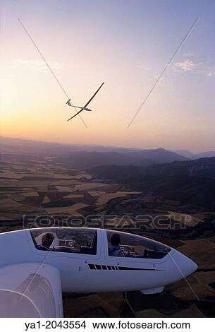Glider planes Twin Astir and ASH-25 flying on sunset near Santa Cilia de Jaca, Aragon, Spain. View Large Photo Image Picture - Glider planes Twin Astir and ASH-25 flying on sunset near Santa Cilia de Jaca, Aragon, Spain.. Fotosearch