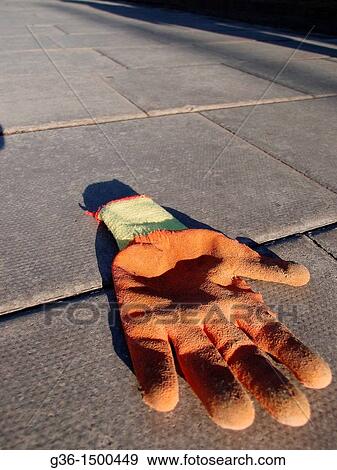 Stock Photo - Glove left on the sidewalk in London, England. Fotosearch