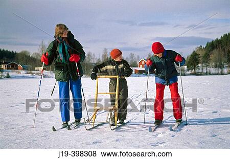 Going by kick-sledge and skis. Family. Sweden View Large Photo Image Stock Photo - Going by kick-sledge and skis. Family. Sweden. Fotosearch