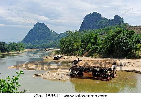 Stock Image - gold digger's barge on Lo river, Ha Giang province, Northern Vietnam, southeast asia. Fotosearch