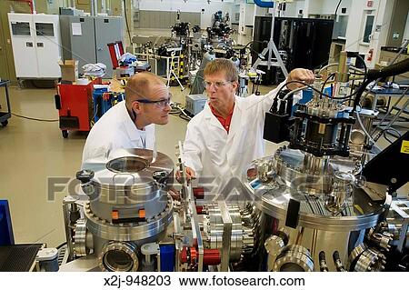 Stock Image - Golden, Colorado - Research scientist Matthew Page left and master research technician Marc Landry work on an experiment aimed at developing photovoltaic technology at the National Renewable Energy Laboratory, operated by the US Department of Energy. Fotosearch