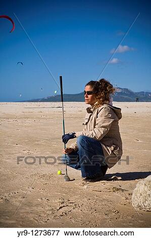 Golf training doesn? t have to be on a green. An uncrowded beach in winter is actually a perfect place to do it. It even has its special appeal for its weirdness, given the presence -in this case on Tarifa beach, Spain- of kiteboarders in the background View Large Photo Image Stock Photo - Golf training doesn? t have to be on a green. An uncrowded beach in winter is actually a perfect place to do it. It even has its special appeal for its weirdness, given the presence -in this case on Tarifa beach, Spain- of kiteboarders in the background. Fotosearch