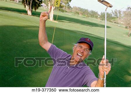 Stock Image - golfer after a wining shot. Fotosearch