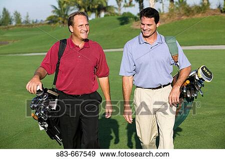 Golfers walking down fairway View Large Photo Image Stock Photo - Golfers walking down fairway. Fotosearch