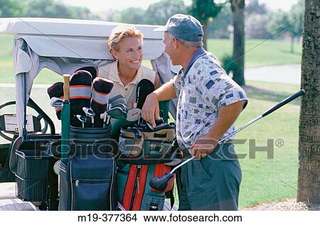 golfing couple chat View Large Photo Image Picture - golfing couple chat. Fotosearch