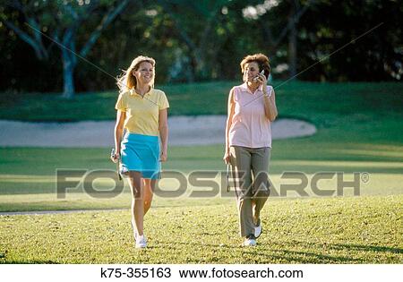 Golfing mother and daughter View Large Photo Image Stock Image - Golfing mother and daughter. Fotosearch