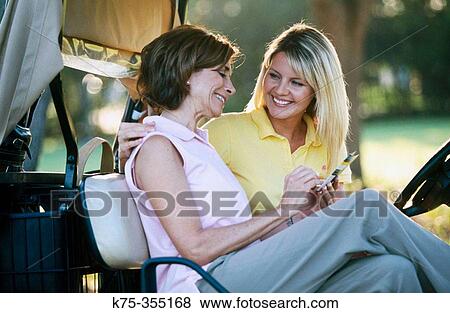 Golfing mother and daughter writing the scorecard View Large Photo Image Stock Photo - Golfing mother and daughter writing the scorecard. Fotosearch