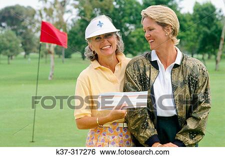 Golfing women showing their score cards View Large Photo Image Stock Photograph - Golfing women showing their score cards. Fotosearch