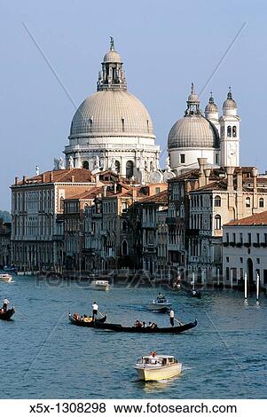Gondola and boats on the Grand Canal in front of Santa Maria della Salute church. Venice, Italy View Large Photo Image Stock Photo - Gondola and boats on the Grand Canal in front of Santa Maria della Salute church. Venice, Italy. Fotosearch