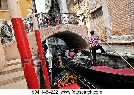 Gondola and gondolier in a canal, Venice, Veneto, Italy View Large Photo Image Stock Image - Gondola and gondolier in a canal, Venice, Veneto, Italy. Fotosearch