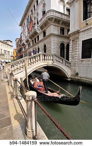 Gondola and gondolier in a canal, Venice, Veneto, Italy View Large Photo Image Stock Photo - Gondola and gondolier in a canal, Venice, Veneto, Italy. Fotosearch