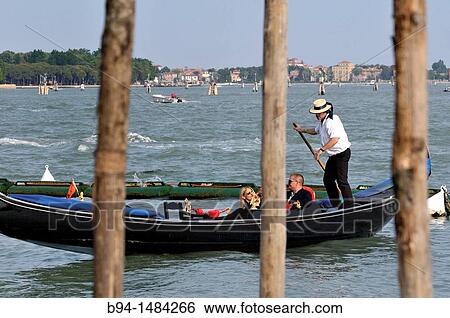 Gondola and gondolier, Venice, Veneto, Italy View Large Photo Image Stock Photograph - Gondola and gondolier, Venice, Veneto, Italy. Fotosearch