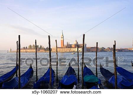 Gondola moored at Molo San Marco in Venice Italy with San Giorgio Maggiore in the background View Large Photo Image Stock Photo - Gondola moored at Molo San Marco in Venice Italy with San Giorgio Maggiore in the background. Fotosearch
