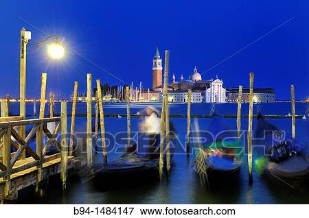 Gondolas and gondolier from Riva degli Schiavoni with San Giorgio Maggiore island in background, Venice, Veneto, Italy View Large Photo Image Stock Photo - Gondolas and gondolier from Riva degli Schiavoni with San Giorgio Maggiore island in background, Venice, Veneto, Italy. Fotosearch