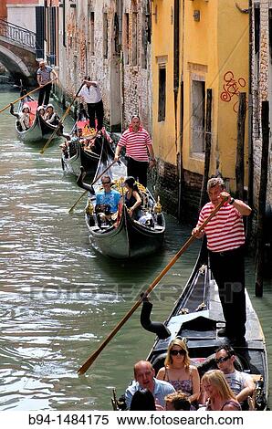 Gondolas and gondoliers in a canal, Venice, Veneto, Italy View Large Photo Image Stock Photography - Gondolas and gondoliers in a canal, Venice, Veneto, Italy. Fotosearch
