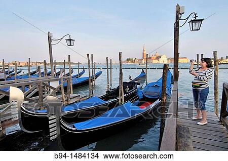 Gondolas at Riva degli Schiavoni and San Giorgio Maggiore island in background, Venice, Veneto, Italy View Large Photo Image Picture - Gondolas at Riva degli Schiavoni and San Giorgio Maggiore island in background, Venice, Veneto, Italy. Fotosearch