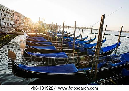 Gondolas moored at the St. Mark's basin during sunrise, Venice, Italy View Large Photo Image Stock Photo - Gondolas moored at the St. Mark's basin during sunrise, Venice, Italy. Fotosearch