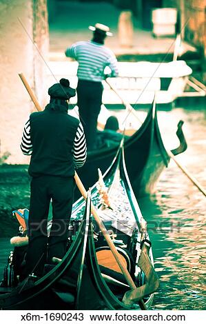 Stock Image - Gondolier and gondola Venice, Italy. Fotosearch