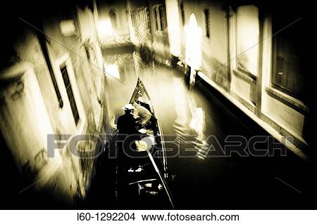 Picture - Gondolier in the canal, Venice, Italy. Fotosearch