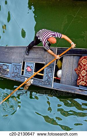 Gondolier on his gondola, Venice, Italy. View Large Photo Image Stock Photo - Gondolier on his gondola, Venice, Italy.. Fotosearch