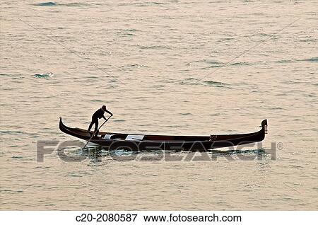 Gondolier rowing on Canal grande, sunset, Venice, Italy. View Large Photo Image Stock Photo - Gondolier rowing on Canal grande, sunset, Venice, Italy.. Fotosearch