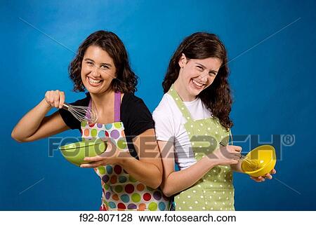 Good friends posing with cooking Bowls, Whisks, Spoons, Aprons View Large Photo Image Stock Photo - Good friends posing with cooking Bowls, Whisks, Spoons, Aprons. Fotosearch