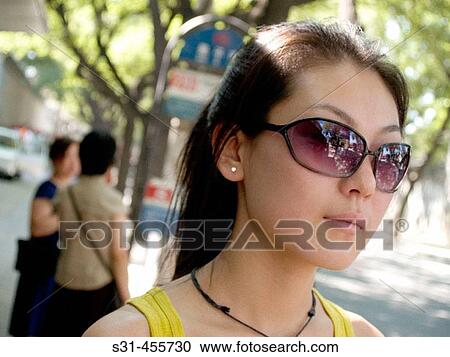 Good looking chinese girl at a bus stop View Large Photo Image Stock Image - Good looking chinese girl at a bus stop. Fotosearch