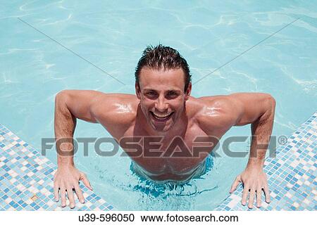 Good-looking man in a swimming pool in India, smiling at camera. View Large Photo Image Stock Image - Good-looking man in a swimming pool in India, smiling at camera.. Fotosearch