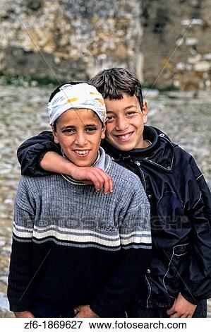 Good looking young boy teenagers hugging Muslim in modern dress in Casablanca Morocco Africa View Large Photo Image Stock Photo - Good looking young boy teenagers hugging Muslim in modern dress in Casablanca Morocco Africa. Fotosearch