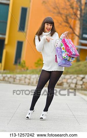 Stock Image - Good shopping, many bags, young woman. Fotosearch