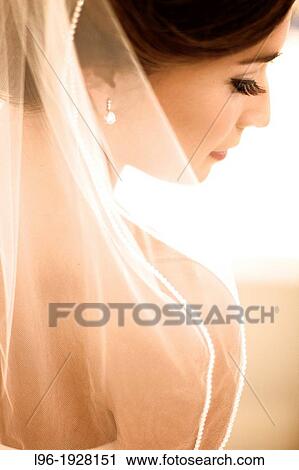 Stock Image - gorgeous bride preparing and anticipating her wedding after hair, makeup, veil, wedding dress are perfect. Fotosearch