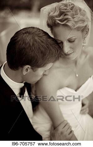 gorgeous couple just married, stealing a private embrace / kiss View Large Photo Image Stock Photo - gorgeous couple just married, stealing a private embrace / kiss. Fotosearch