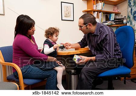 GP Doctor rewards child patient with stickers for her during a consultation View Large Photo Image Stock Image - GP Doctor rewards child patient with stickers for her during a consultation. Fotosearch