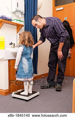 GP Doctor surgery patient consultation Child weight measurement View Large Photo Image Stock Image - GP Doctor surgery patient consultation Child weight measurement. Fotosearch