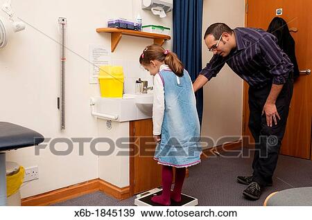 GP Doctor surgery patient consultation Child weight measurement View Large Photo Image Stock Photo - GP Doctor surgery patient consultation Child weight measurement. Fotosearch