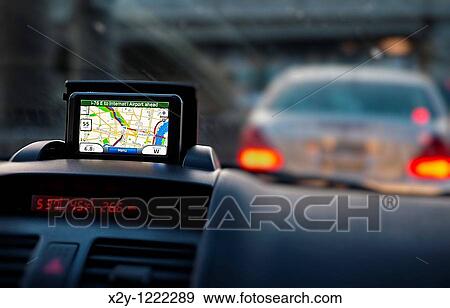 Stock Photo - GPS unit on the dashboard of a car. Fotosearch