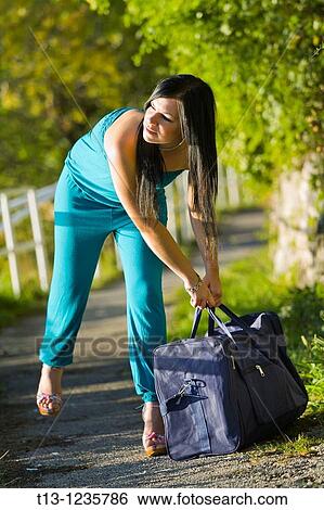 Grabbing a big bag View Large Photo Image Stock Photograph - Grabbing a big bag. Fotosearch