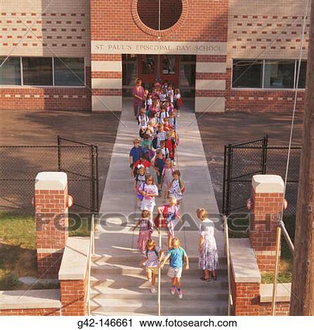 Stock Image - Grade school kids exit school. Fotosearch