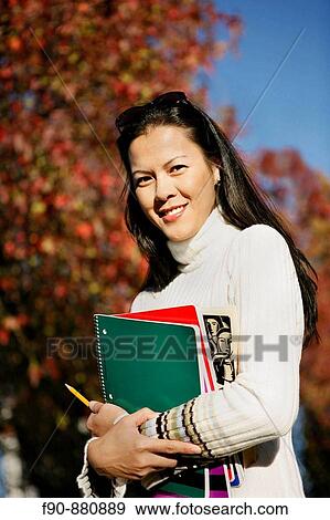 Stock Photo - Graduate student w autumn leaves MR. Fotosearch