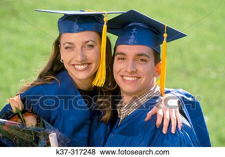 Stock Photo - Graduates at graduation ceremony on campus. Fotosearch