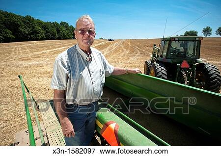 Grain producer standing on platform of grain drill Montgomery County Maryland USA View Large Photo Image Stock Photo - Grain producer standing on platform of grain drill Montgomery County Maryland USA. Fotosearch