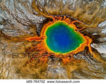 Stock Image - Grand Prismatic Spring Midway Geyser Basin Yellowstone National Park Wyoming USA Considered to be the largest hot spring in Yellowstone Discharges about 550 gallons of water poer minute. Fotosearch