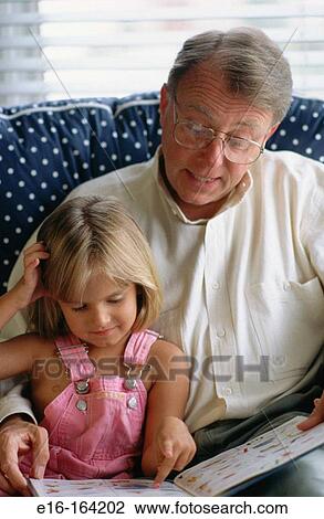 Grandfather and grand daughter reading View Large Photo Image Stock Image - Grandfather and grand daughter reading. Fotosearch