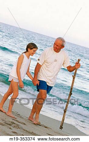Grandfather and Grandaughter at the beach View Large Photo Image Picture - Grandfather and Grandaughter at the beach. Fotosearch