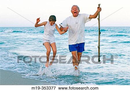 Grandfather and Grandaughter at the beach View Large Photo Image Stock Photo - Grandfather and Grandaughter at the beach. Fotosearch
