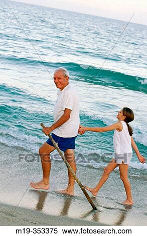 Grandfather and Grandaughter at the beach View Large Photo Image Stock Photography - Grandfather and Grandaughter at the beach. Fotosearch