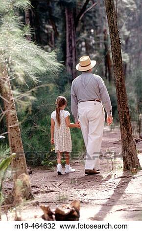 Grandfather and granddaughter walk hand in hand in the woods View Large Photo Image Stock Image - Grandfather and granddaughter walk hand in hand in the woods. Fotosearch