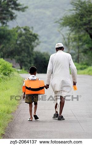 Grandfather And Grandson holding hands on way to school, Maharashtra, India. View Large Photo Image Stock Photo - Grandfather And Grandson holding hands on way to school, Maharashtra, India.. Fotosearch