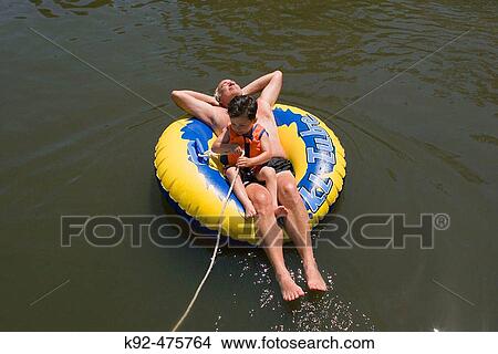 Grandfather and grandson in the water. View Large Photo Image Picture - Grandfather and grandson in the water.. Fotosearch